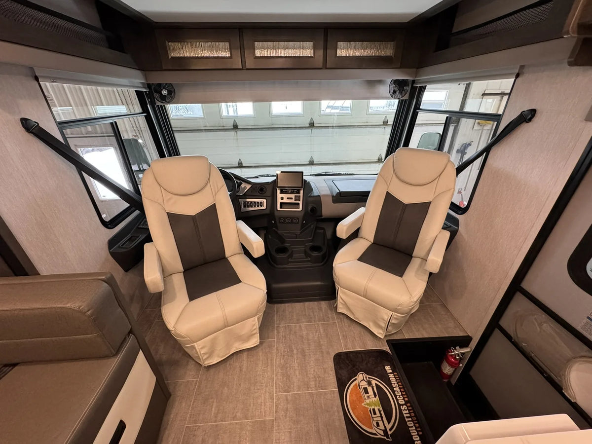 Cabine de conduite avec deux sièges pivotants.