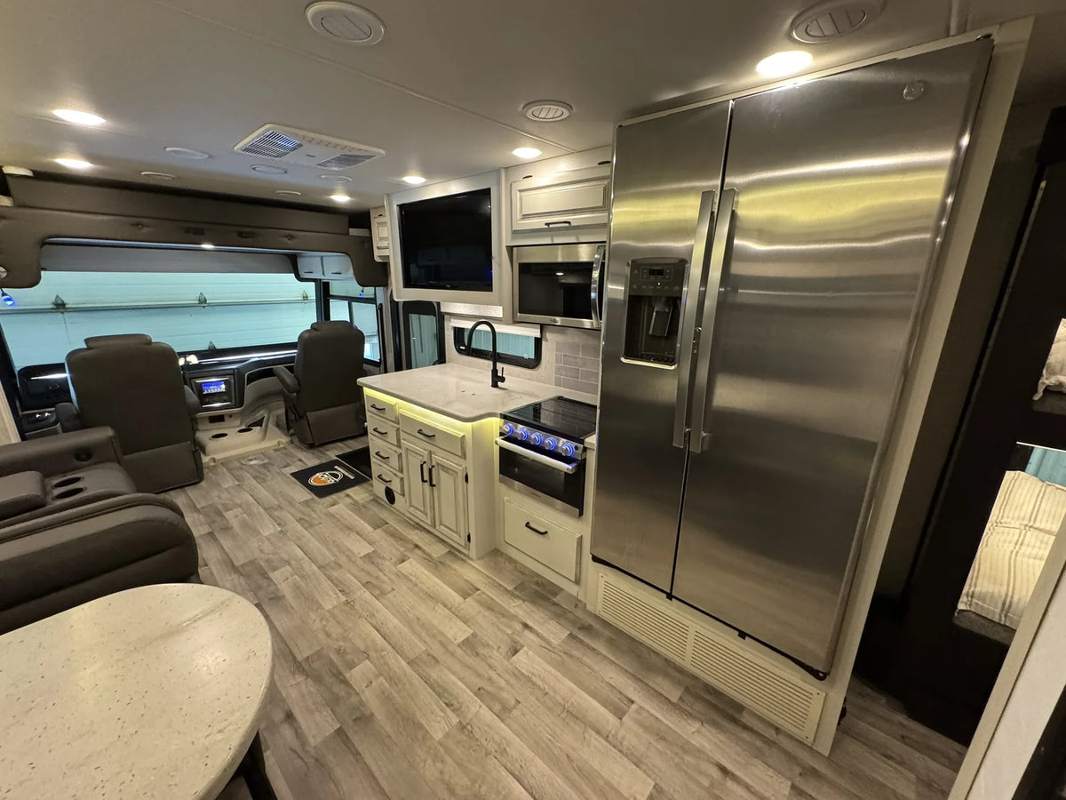 Cuisine du Jayco Precept 36A 2023 avec armoires, four à micro-ondes et réfrigérateur.